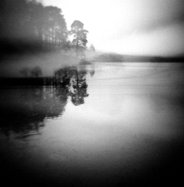 Image taken with a Holga medium format 120 film toy camera of misty view of Blea Tarn at dawn