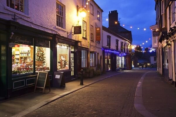 Independent shops and Christmas lights on Kirkgate, Ripon, North Yorkshire, Yorkshire, England, United Kingdom, Europe