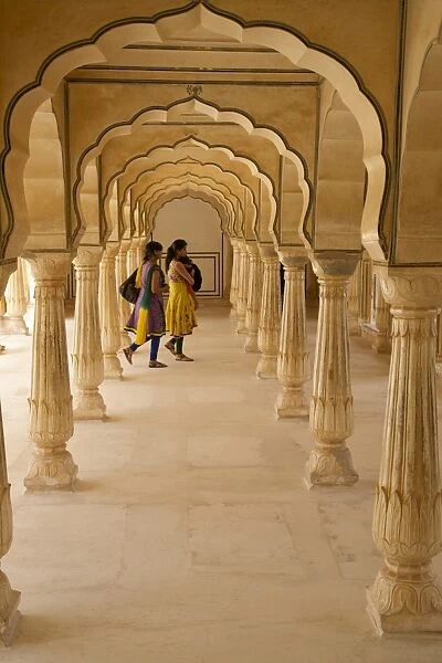 Indian women under arches, Amber Fort Palace, Jaipur, Rajasthan, India, Asia