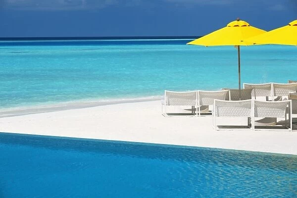 Infinity pool and lounge chairs, Maldives, Indian Ocean, Asia