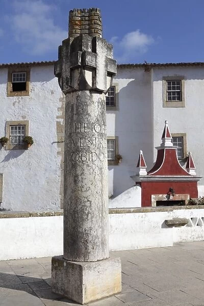 Inscribed column at the entrance gate to the medieval walled city of Obidos, Estremadura, Portugal, Europe