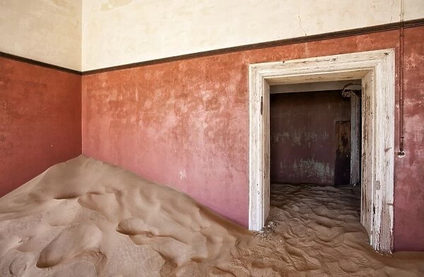 Interior of building slowly being consumed by the sands of the Namib Desert in the abandoned former German diamond mining town of Kolmanskop, Forbidden Diamond Area near Luderitz, Namibia, Africa