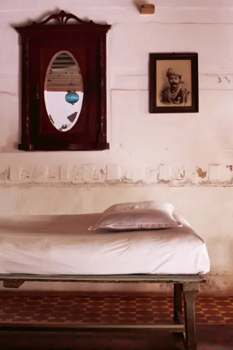 Framed Print : Interior detail of day bed with old photograph of a Framed Print : Interior detail of day bed with old photograph of a