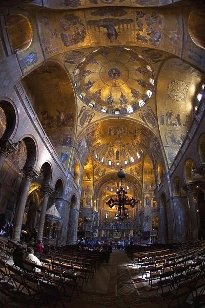 Interior of St. Marks Basilica (Basilica di San Marco) with golden Byzantine mosaics illuminated in the nave, Venice, UNESCO World Heritage Site, Veneto