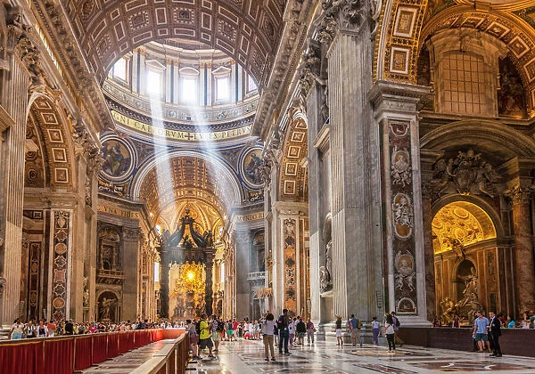 Interior of St. Peters Basilica with light shafts coming through the dome roof, Vatican City