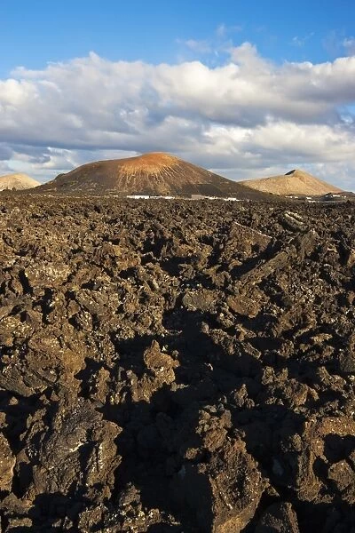 Irregular blocky lava (a a) and cinder cones of the volcanic landscape of Timanfaya National Park, Lanzarote, Canary Islands, Spain, Atlantic