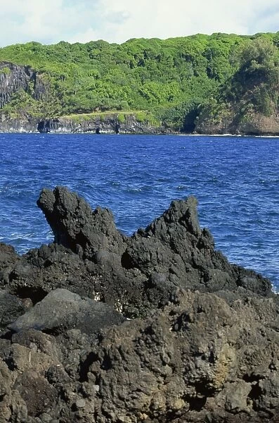 Jagged black lava shore on Keanae Peninsula, Hana Coast road, Maui, Hawaii
