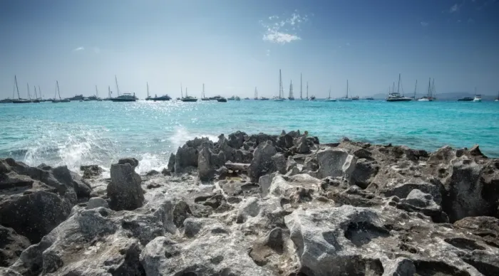 Framed Print : Jagged rocks with sailboats idling in the azure waters of Formentera, Balearic Islands Framed Print : Jagged rocks with sailboats idling in the azure waters of Formentera, Balearic Islands