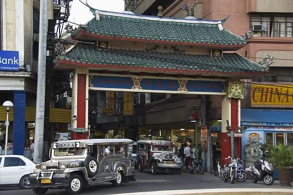 Jeepney driving under Chinatown Gate, Manila, Philippines, Southeast Asia, Asia