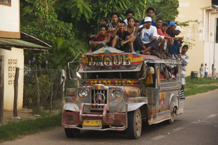 Framed Print : Jeepney truck with passengers crowded on roof Framed Print : Jeepney truck with passengers crowded on roof