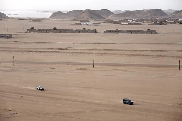 Jeeps cover the wide expanse of desert between Lake