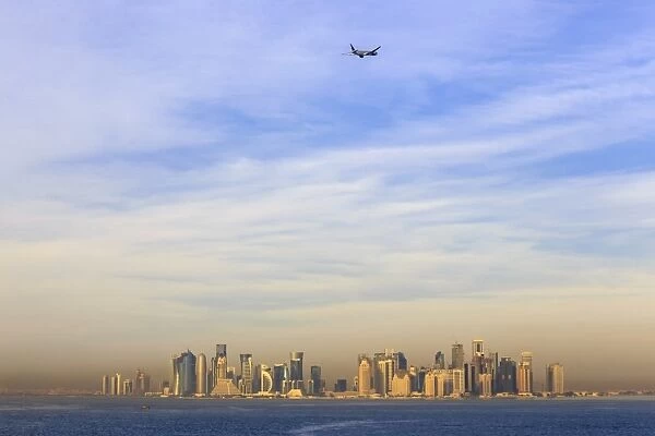 Jet airplane after take off from Hamad International Airport, seen above Doha city