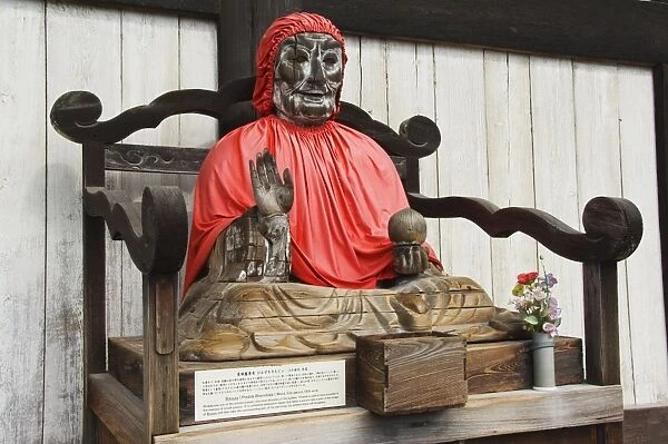 Jizo Buddha statue dressed in red cape