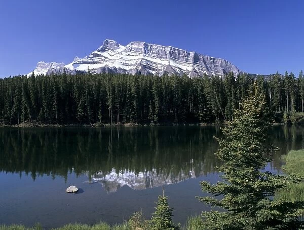 Johnson Lake with snowy peak of Mount Rundle reflected in the water, Banff National Park