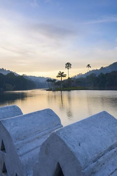 Kandy Lake at sunrise, the island of the Royal Summer House, with the Clouds Wall in the foreground, Kandy, Sri Lanka, Asia