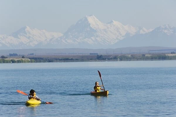 Kayaking on Lake Benmore and a distant Aoraki (Mount Cook)