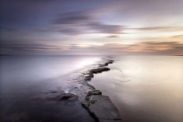 Kimmeridge Bay at dusk showing wave-cut platform known locally as The Flats