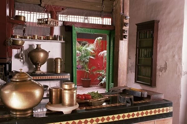 Kitchen area with traditional brass cooking utensils