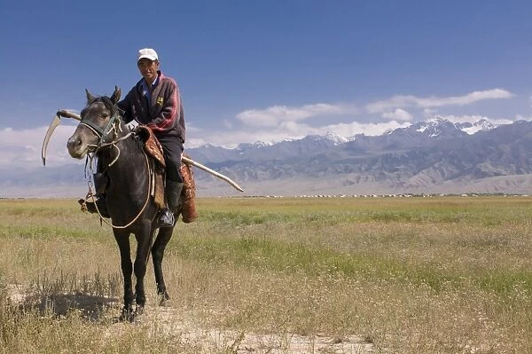 Kyrgyz man on his way to harvest, Torugat Pass, Kyrgyzstan, Central Asia, Asia