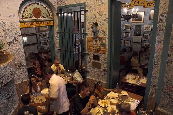 La Bodeguita del Medio restaurant, with signed walls and people eating at tables