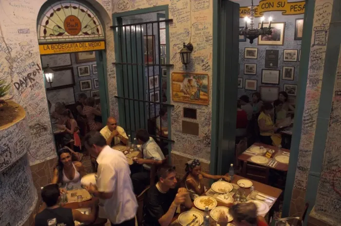 Framed Print : La Bodeguita del Medio restaurant, with signed walls and people eating at tables Framed Print : La Bodeguita del Medio restaurant, with signed walls and people eating at tables