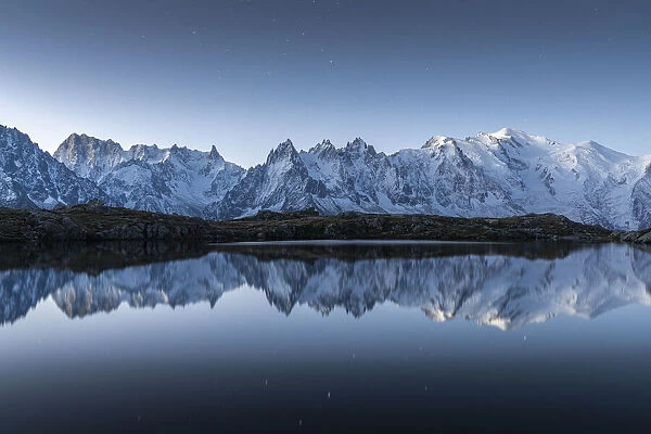 Lacs des Cheserys lake and peaks of Mont Blanc massif covered with snow at night