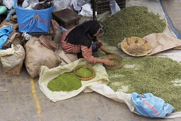 Lady grinding spices in Rahba Kedima (Old Square), Marrakech, Morocco, North Africa, Africa
