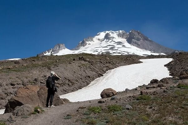Lady hiker near a glacier on Mount Hood, part of the Cascade Range, Pacific Northwest region