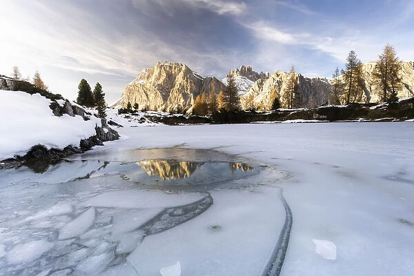 Lagazuoi mountain mirrored in the icy lake Limides at dawn, Ampezzo Dolomites