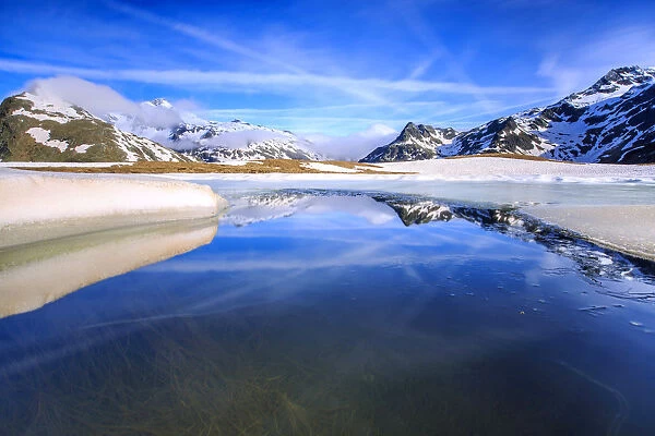 Lake Andossi during spring thaw, Chiavenna Valley, Spluga Valley, Sondrio province
