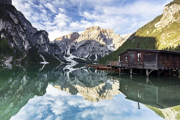 Lake Braies (Pragser Wildsee) at sunrise with Croda del Becco mountain reflected in water