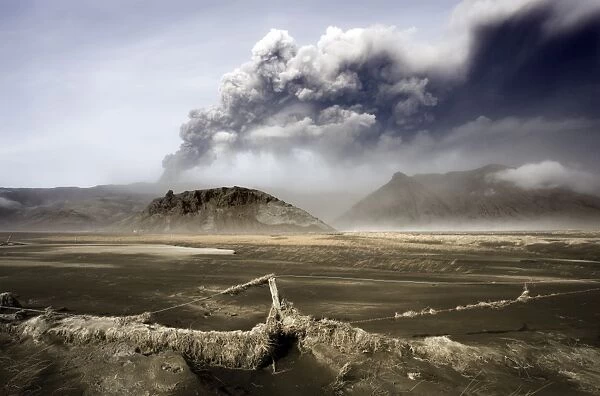 Landscape covered in volcanic ash and dust with the ash plume of the Eyjafjallajokull eruption in the distance, southern area, Iceland