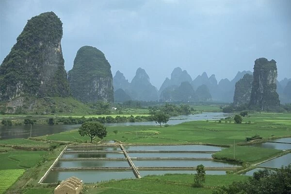 Landscape of rice paddies, fish farms and limestone pinnacles in the Fenglin Karst south of Guilin