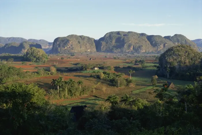 Framed Print : Landscape view of fields and trees in valley, with hills beyond, Vinales Valley Framed Print : Landscape view of fields and trees in valley, with hills beyond, Vinales Valley