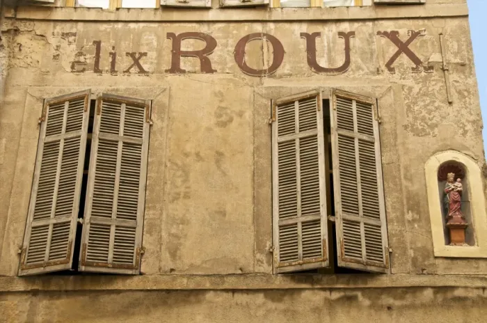 Framed Print : Large painted letters on ancient wall, with statue of the Virgin, and wood shutters