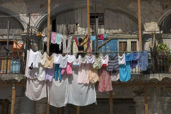 Large quantity of laundry hanging from the balcony of a crumbling building
