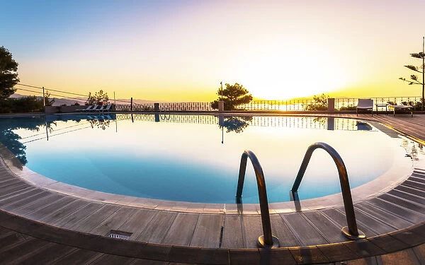 Large swimming pool and sunset over Chania, Crete, Greek Islands, Greece, Europe