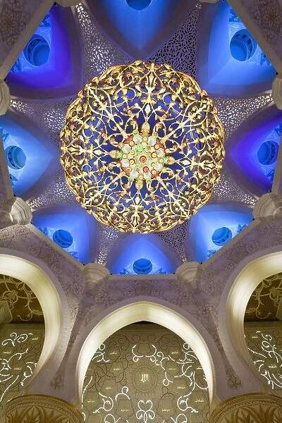 The largest ornate chandelier in the world hanging from the main dome inside the prayer hall of Sheikh Zayed Bin Sultan Al Nahyan Mosque, Abu Dhabi, United Arab Emirates