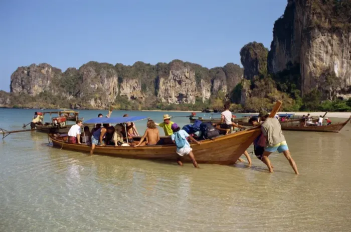 Framed Print : Launching a long tail boat full of backpackers from Framed Print : Launching a long tail boat full of backpackers from