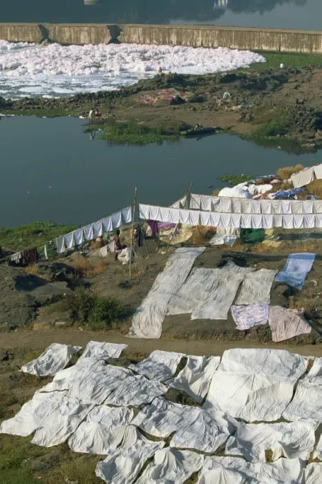 Framed Print : Laundry drying by the Mula River, with foam from detergent pollution beyond Framed Print : Laundry drying by the Mula River, with foam from detergent pollution beyond