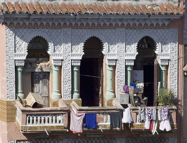 Laundry hanging from the balcony of an ornate Moorish style building in central Havana