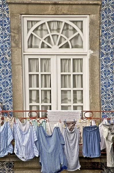 Laundry hanging from window in the Ribeira Quarter, Oporto, Portugal, Europe