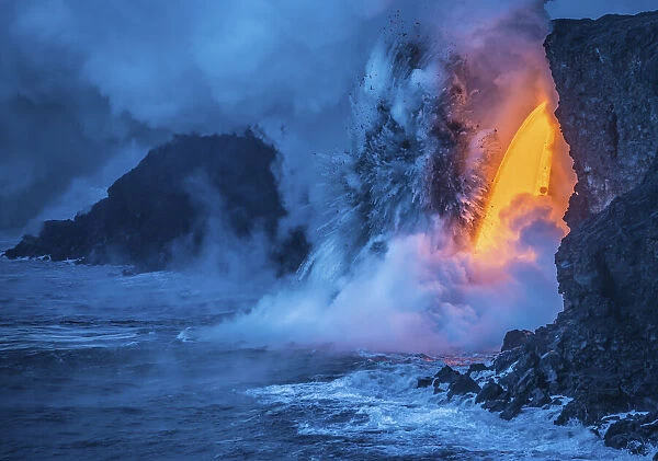 A Lava fall pours from a lava tube 60 feet high, the heat