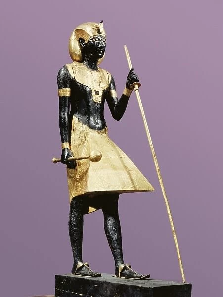 Life size statue of Tutankhamun made from black wood with applied gilded plaster