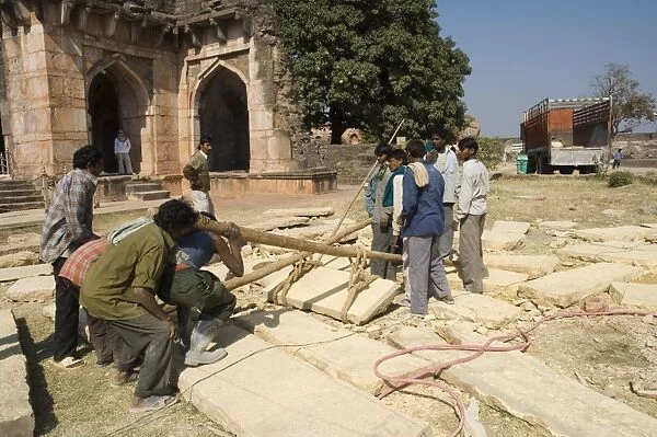 Lifting by hand heavy stones for restoration work