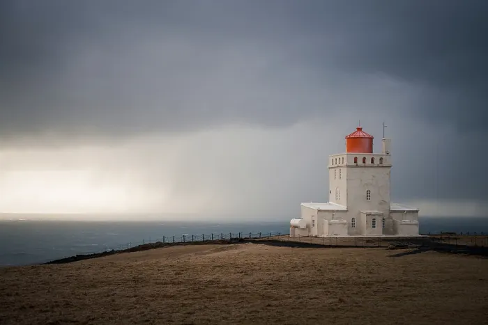 Framed Print : The lighthouse of Dyrholaey on a stormy day, southern coast of Iceland, Polar Regions