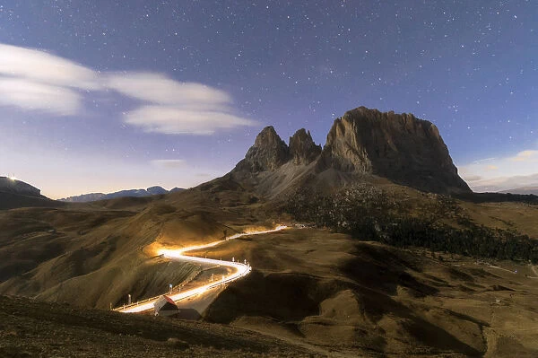 Lights of car trails with Sassopiatto in the background, Dolomites, South Tyrol, Italy