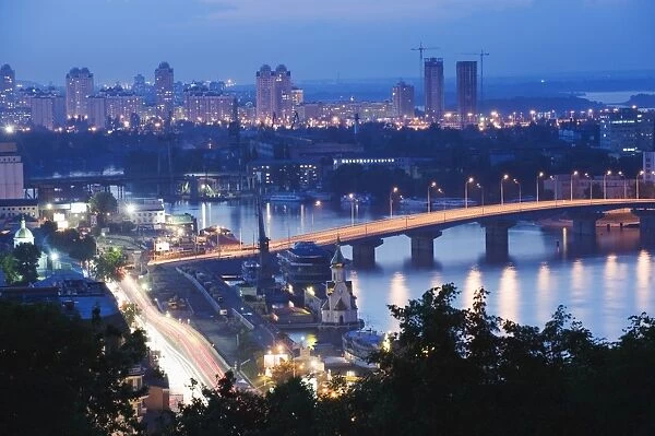 Lights illuminating Podil district and Dnieper River area at night, Kiev, Ukraine, Europe