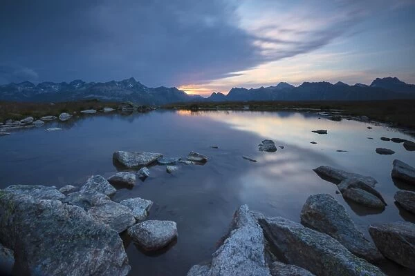 The lights of sunrise reflected in the alpine lake, Muottas Muragl, Samedan, Canton of Graubunden
