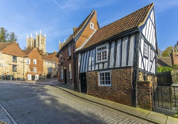 Lincoln Cathedral and timbered architecture viewed from the cobbled Steep Hill, Lincoln